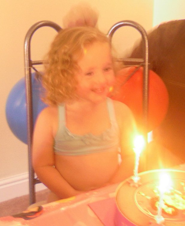 Louisa blowing candles out